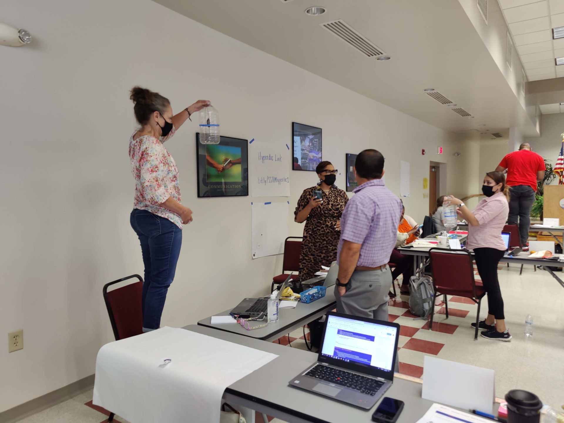 Educators demonstrate freefall with the Astronaut in a Bottle activity.
