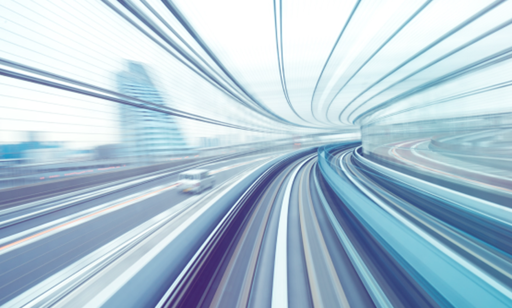 Blurred motion of urban train speeds through city