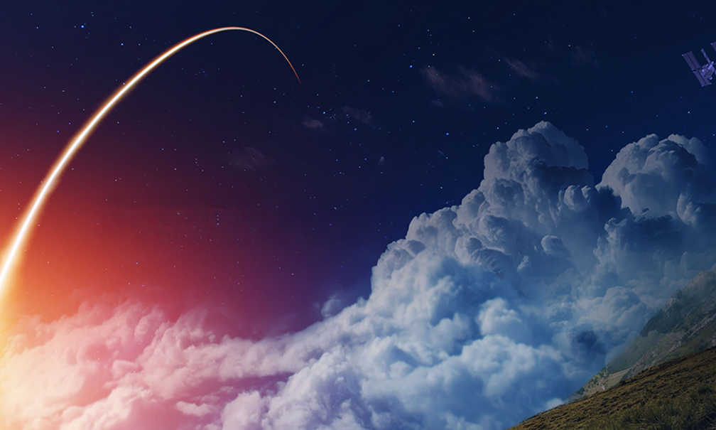 Spectacular rocket launch over cloud-covered landscape at night