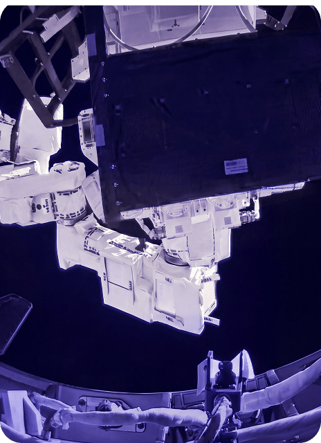 Astronaut performs spacewalk outside spacecraft.