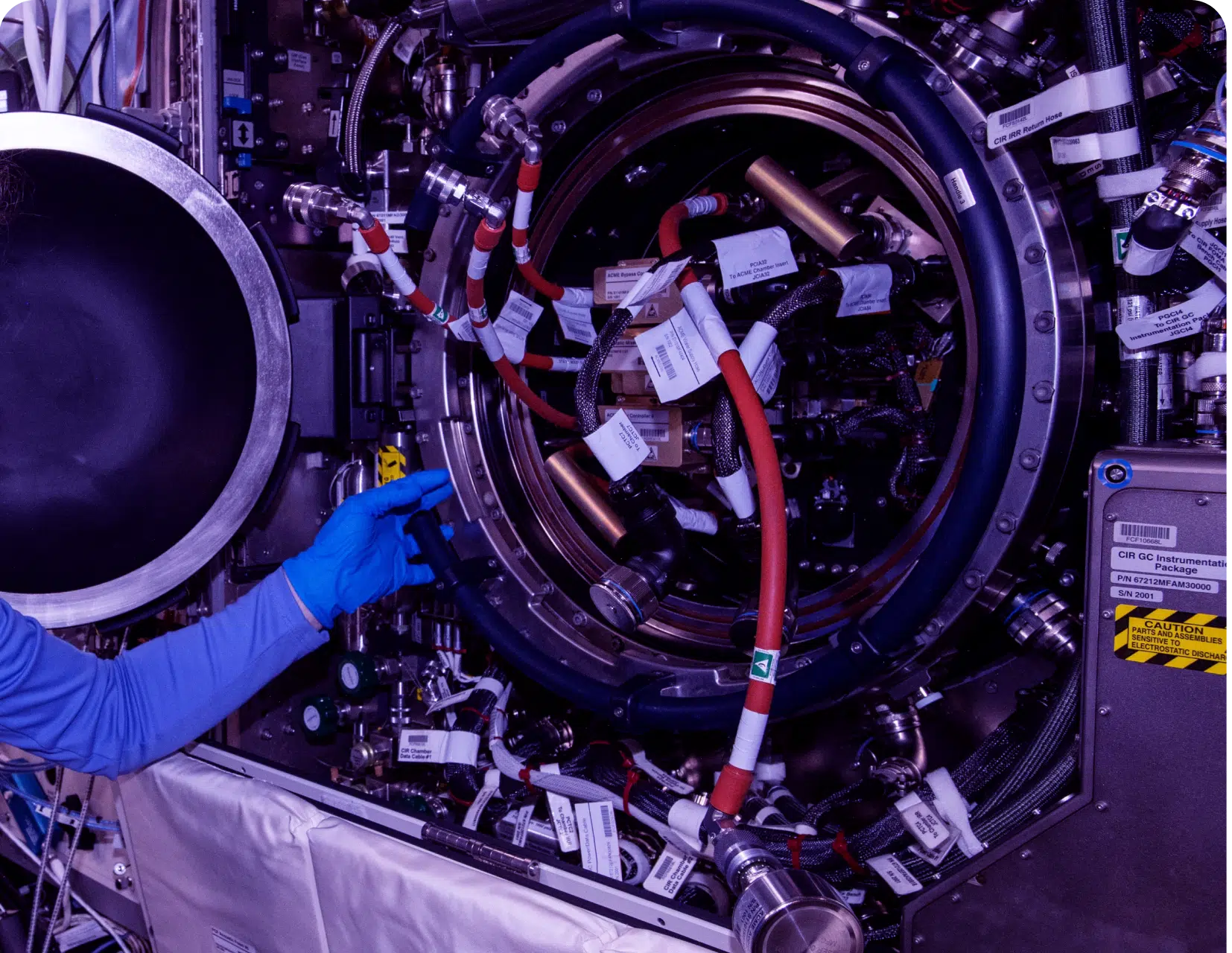 Technician working on complex industrial machinery.