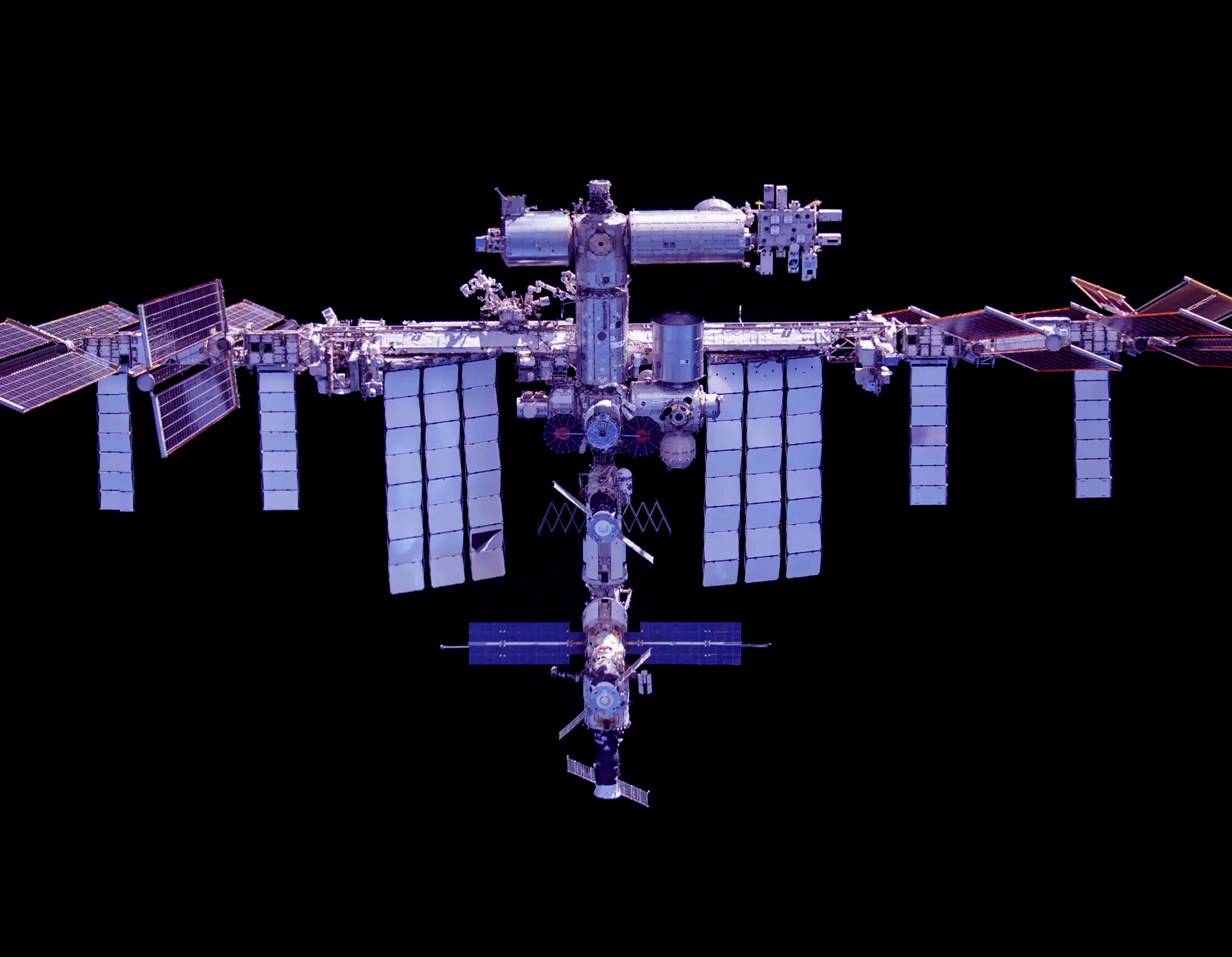 International Space Station in orbit against black sky.