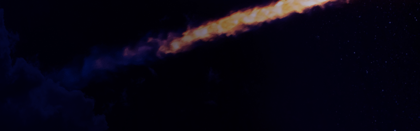 Fiery meteor streaks across dark night sky.