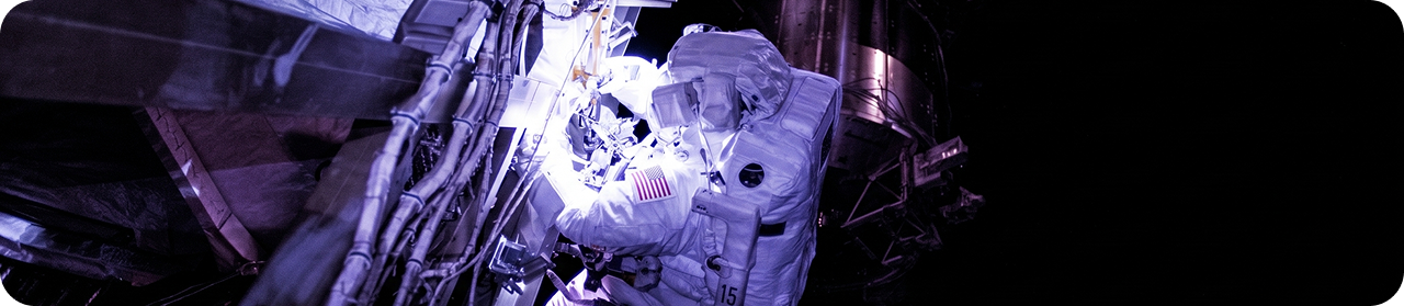 Astronaut performing spacewalk outside spacecraft