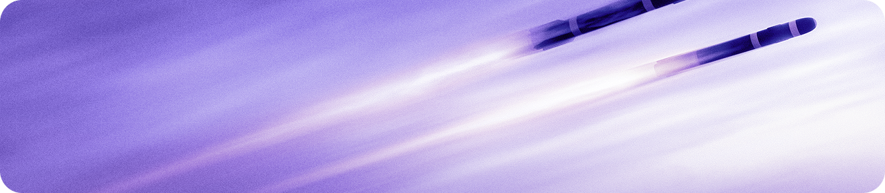 Two rockets flying through purple sky.