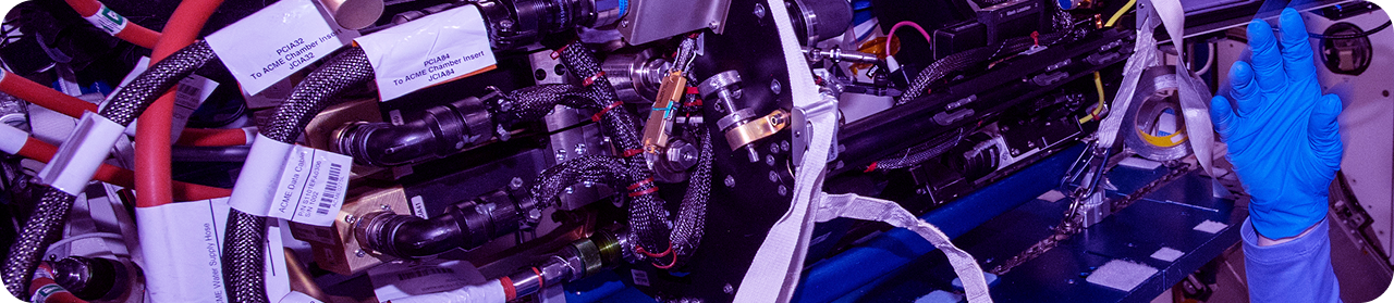 Technician repairs complex machinery with blue glove