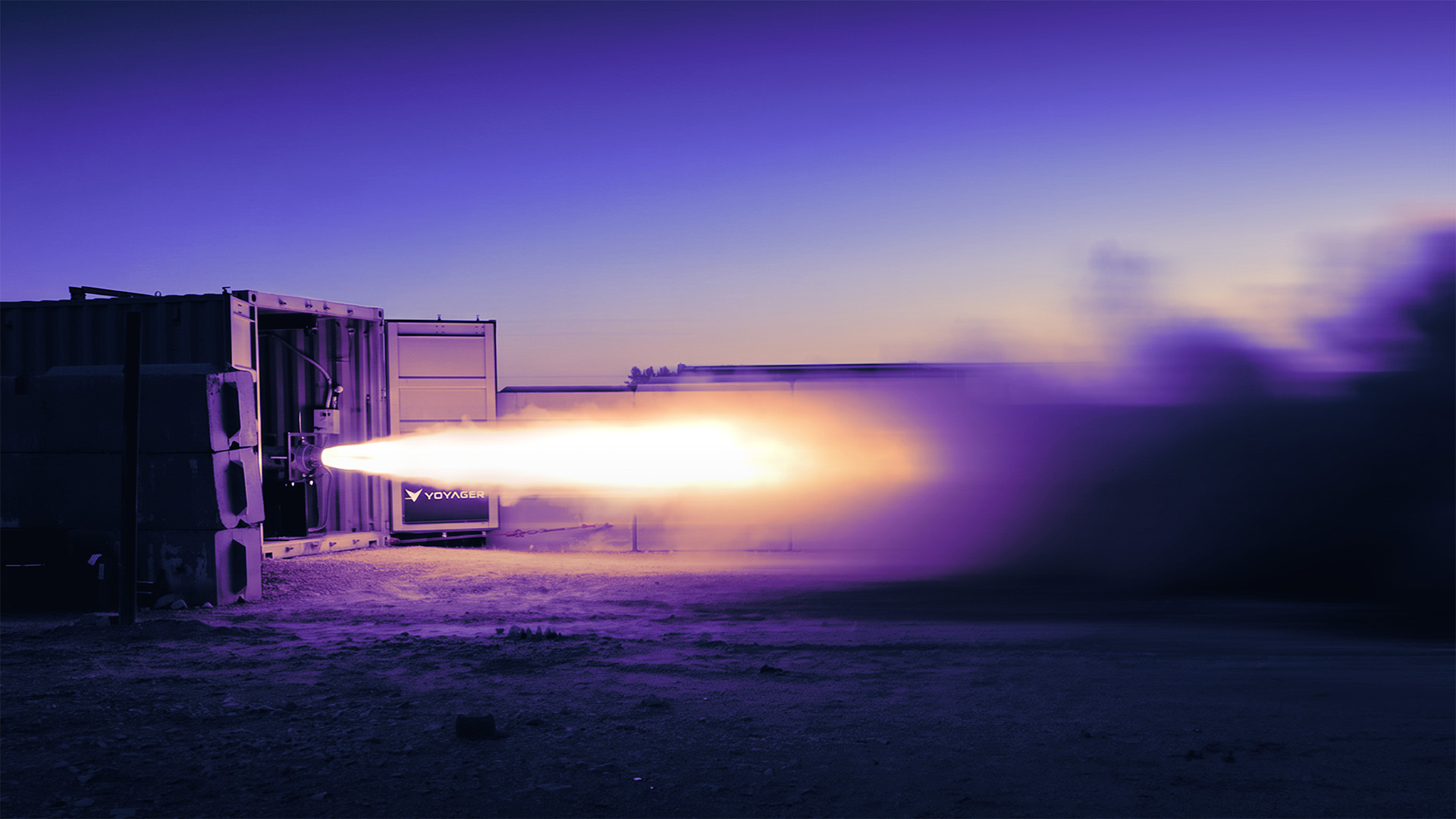 Rocket engine test firing from container at dusk